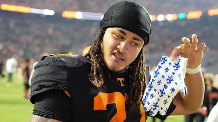 Tennessee running back Peyton Lewis (27) holds up a Kentucky branded glove as he leaves the field after the win over Kentucky in an NCAA college football game on Saturday, Nov. 2, 2024, in Knoxville, Tenn.