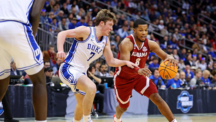 Mar 29, 2025; Newark, NJ, USA; Alabama Crimson Tide guard Chris Youngblood (8) drives to the basket against Duke Blue Devils guard Kon Knueppel (7) during the second half in the East Regional final of the 2025 NCAA tournament at Prudential Center. Mandatory Credit: Vincent Carchietta-Imagn Images