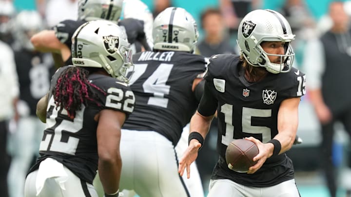 Nov 17, 2024; Miami Gardens, Florida, USA; Las Vegas Raiders quarterback Gardner Minshew (15) fakes a handoff to running back Alexander Mattison (22) in the fourth quarter at Hard Rock Stadium. Mandatory Credit: Jim Rassol-Imagn Images