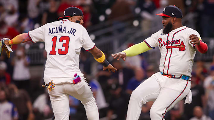 Atlanta Braves right fielder Ronald Acuna Jr. (13) and designated hitter Marcell Ozuna (20) celebrate after a victory over the Chicago Cubs at Truist Park.