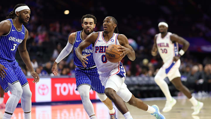 Oct 10, 2025; Philadelphia, Pennsylvania, USA; Philadelphia 76ers guard Tyrese Maxey (0) drives past Orlando Magic guard Tyus Jones (2) during the first quarter at Xfinity Mobile Arena. Mandatory Credit: Bill Streicher-Imagn Images Oct 10, 2025; Philadelphia, Pennsylvania, USA; Philadelphia 76ers guard Tyrese Maxey (0) drives past Orlando Magic guard Tyus Jones (2) during the first quarter at Xfinity Mobile Arena. Mandatory Credit: Bill Streicher-Imagn Images