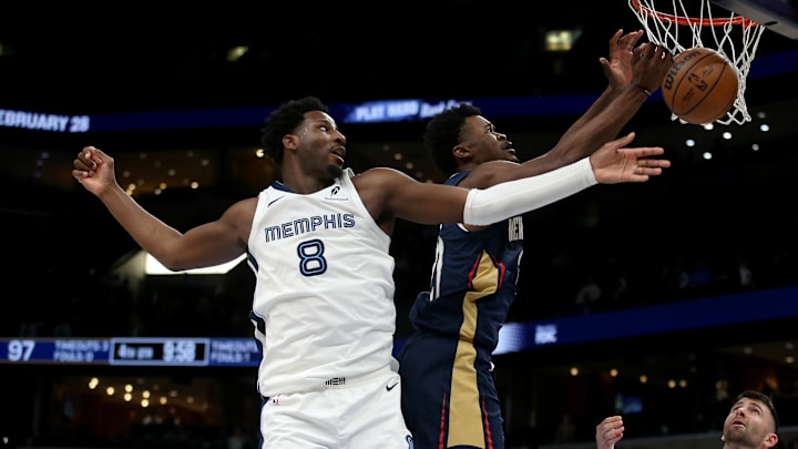 Jan 23, 2026; Memphis, Tennessee, USA; Memphis Grizzlies forward/center Jaren Jackson Jr. (8) and New Orleans Pelicans center Yves Missi (21) reach for a rebound during the fourth quarter at FedExForum. Mandatory Credit: Petre Thomas-Imagn Images