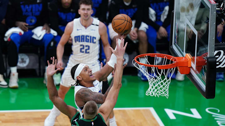 Orlando Magic forward Paolo Banchero (5) drives to the basket against Boston Celtics center Kristaps Porzingis (8) in the first quarter during game five of first round for the 2025 NBA Playoffs at TD Garden. 