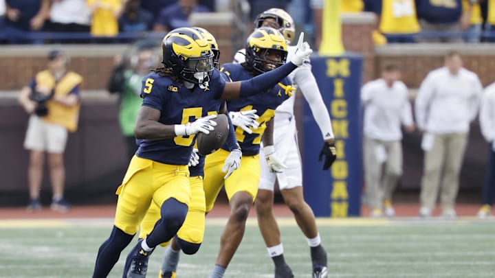 Oct 18, 2025; Ann Arbor, Michigan, USA;  Michigan Wolverines defensive back Jacob Oden (5) celebrates after he makes an interception in the second half against the Washington Huskies at Michigan Stadium. Mandatory Credit: Rick Osentoski-Imagn Images