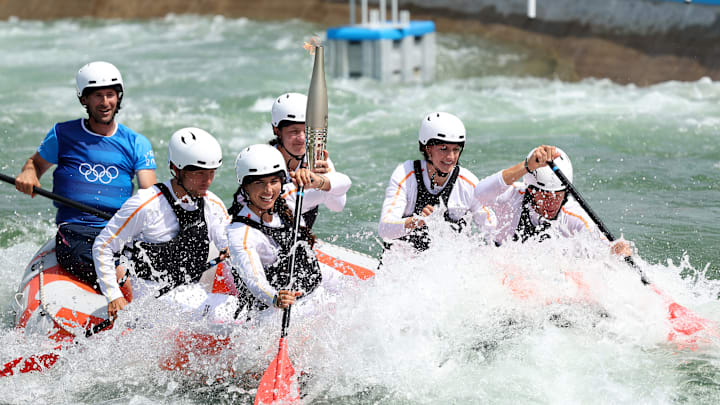 Whitewater rafters carry the Olympic torch on its way to Paris.