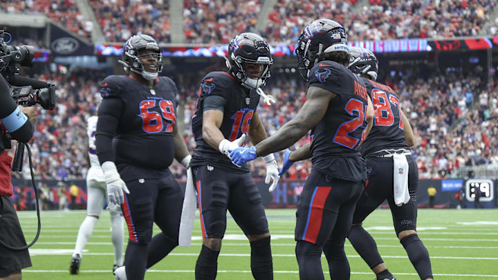 Oct 6, 2024; Houston, Texas, USA; Houston Texans running back Cam Akers (22) celebrates with wide receiver Xavier Hutchinson (19) after scoring a touchdown during the first quarter against the Buffalo Bills at NRG Stadium. Mandatory Credit: Troy Taormina-Imagn Images