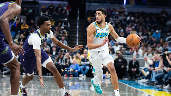 Dec 15, 2024; Indianapolis, Indiana, USA; Indiana Pacers guard Tyrese Haliburton (0) dribbles  the ball while New Orleans Pelicans forward Herbert Jones (2)  defends in the second half at Gainbridge Fieldhouse. Mandatory Credit: Trevor Ruszkowski-Imagn Images