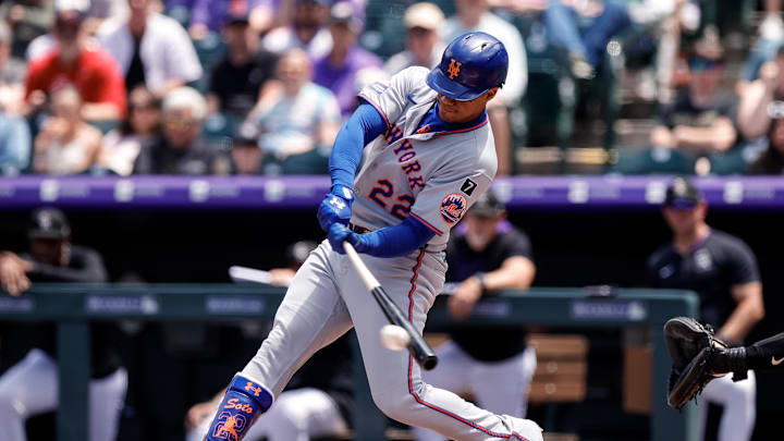 Jun 8, 2025; Denver, Colorado, USA; New York Mets right fielder Juan Soto (22) hits a single in the first inning against the Colorado Rockies at Coors Field. Mandatory Credit: Isaiah J. Downing-Imagn Images