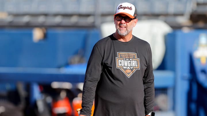 Oklahoma State head coach Kenny Gajewski runs drills during the practice and media day for the Women's College World Series at Devon Park in Oklahoma City, on Wednesday, May 29, 2024.