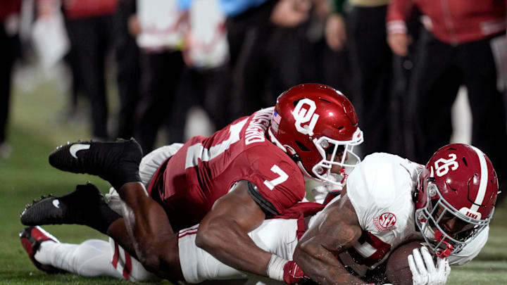 Oklahoma Sooners linebacker Sammy Omosigho (7) brings down Alabama Crimson Tide running back Jamarion Miller (26) during a first-round College Football Playoff game between the University of Oklahoma Sooners (OU) and the Alabama Crimson Tide at Gaylord Family - Oklahoma Memorial Stadium in Norman, Okla., Friday, Dec. 19, 2025. Alabama won 34-24.