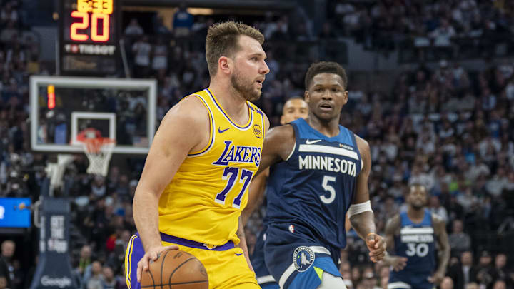 Apr 25, 2025; Minneapolis, Minnesota, USA; Los Angeles Lakers guard Luka Doncic (77) dribbles the ball against the Minnesota Timberwolves during game three of first round for the 2024 NBA Playoffs at Target Center. Mandatory Credit: Jesse Johnson-Imagn Images