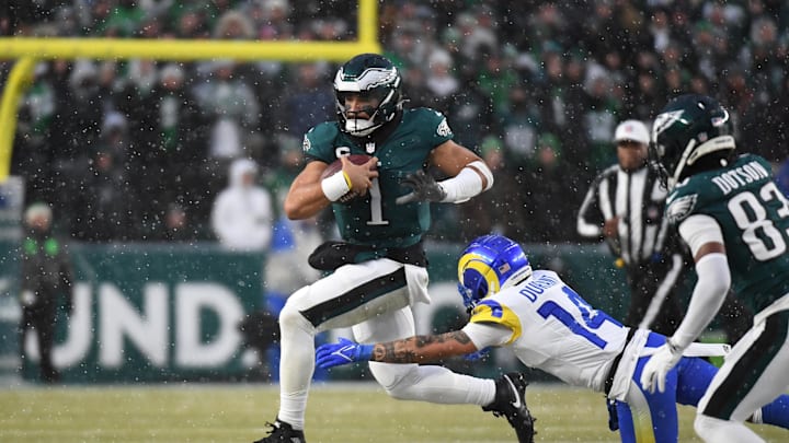 Jan 19, 2025; Philadelphia, Pennsylvania, USA; Philadelphia Eagles quarterback Jalen Hurts (1) runs with the ball as Los Angeles Rams cornerback Cobie Durant (14) tackles during the first half in a 2025 NFC divisional round game at Lincoln Financial Field. 