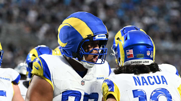 Jan 10, 2026; Charlotte, NC, USA; Los Angeles Rams wide receiver Puka Nacua (12) celebrates with offensive tackle Alaric Jackson (77) after scoring a touchdown in the second quarter in an NFC Wild Card Round game at Bank of America Stadium. Mandatory Credit: Bob Donnan-Imagn Images