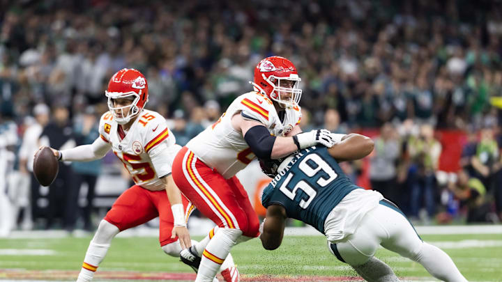 Feb 9, 2025; New Orleans, LA, USA;  Kansas City Chiefs quarterback Patrick Mahomes (15) scrambles as guard Joe Thuney (62) blocks Philadelphia Eagles defensive tackle Thomas Booker IV (59) in Super Bowl LIX at Ceasars Superdome. Mandatory Credit: Mark J. Rebilas-Imagn Images