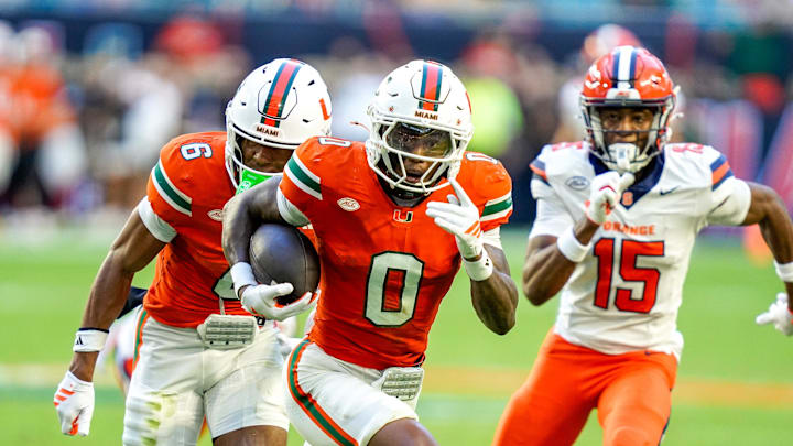 Nov 8, 2025; Miami Gardens, Florida, USA; Miami Hurricanes defensive back Keionte Scott (0) returns an interception for a touchdown in a game against the Syracuse Orange during the second quarter at Hard Rock Stadium. Mandatory Credit: Jeff Romance-Imagn Images