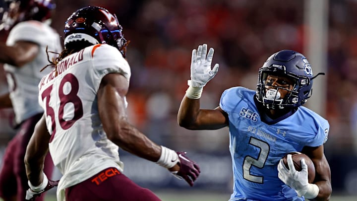 Sep 2, 2022; Norfolk, Virginia, USA;  Old Dominion Monarchs running back Blake Watson (2) runs the ball against Virginia Tech Hokies linebacker Jayden McDonald (38) during the second quarter at Kornblau Field at S.B. Ballard Stadium. Mandatory Credit: Peter Casey-Imagn Images