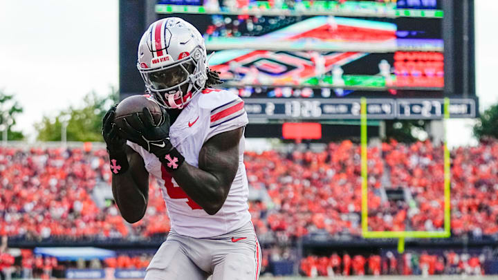 Ohio State Buckeyes wide receiver Jeremiah Smith (4) catches a touchdown pass during the second half of the NCAA football game against the Illinois Fighting Illini at Gies Memorial Stadium in Champaign on Oct. 11, 2025. Ohio State won 34-16.