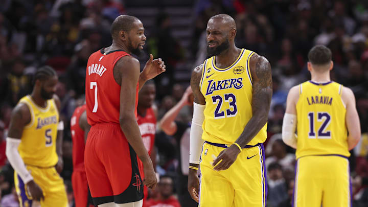 Mar 16, 2026; Houston, Texas, USA; Houston Rockets forward Kevin Durant (7) talks with Los Angeles Lakers forward LeBron James (23) on the court during the second quarter at Toyota Center. Mandatory Credit: Troy Taormina-Imagn Images