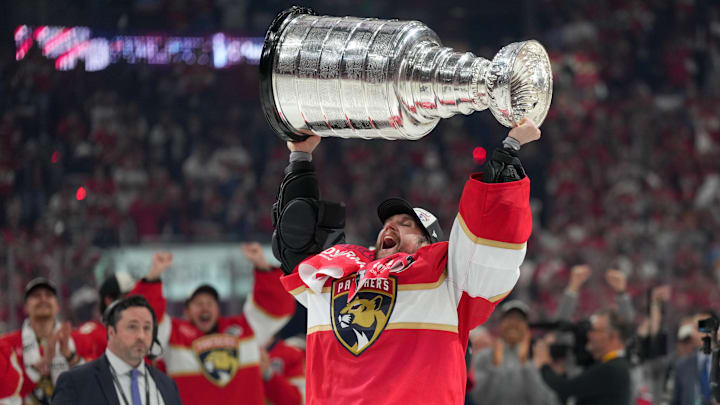 Jun 17, 2025; Sunrise, Florida, USA; Florida Panthers goaltender Sergei Bobrovsky (72) hoists the Stanley Cup after winning game six of the 2025 Stanley Cup Final against the Edmonton Oilers at Amerant Bank Arena. Mandatory Credit: Jim Rassol-Imagn Images