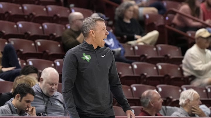 Nov 19, 2023; Charleston, SC, USA; Current WVU and former North Texas head coach Ross Hodge reacts to a call on the court in the first half against the Towson Tigers at TD Arena. Mandatory Credit: David Yeazell-Imagn Images