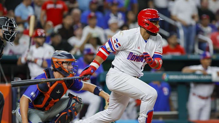 Mar 14, 2023; Miami, Florida, USA; Dominican Republic first baseman Robinson Cano (24) hits an RBI single during the seventh inning against Israel at LoanDepot Park. Mandatory Credit: Sam Navarro-USA TODAY Sports