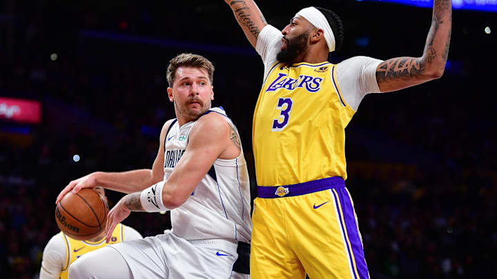 Nov 22, 2023; Los Angeles, California, USA; Dallas Mavericks guard Luka Doncic (77) passes the ball against Los Angeles Lakers forward Anthony Davis (3) during the first half at Crypto.com Arena. Mandatory Credit: Gary A. Vasquez-Imagn Images