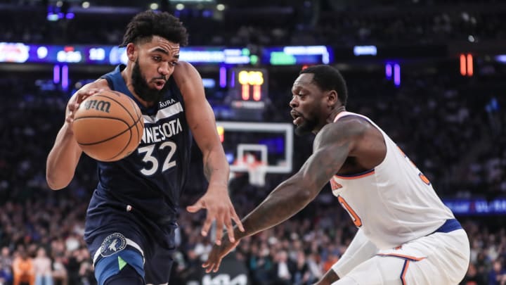 Jan 1, 2024; New York, New York, USA;  Minnesota Timberwolves center Karl-Anthony Towns (32) looks to drive past New York Knicks forward Julius Randle (30) in the first quarter at Madison Square Garden. Mandatory Credit: Wendell Cruz-USA TODAY Sports
