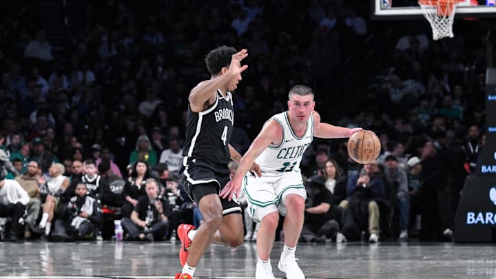 Mar 15, 2025; Brooklyn, New York, USA; Boston Celtics guard Payton Pritchard (11) tries to get past Brooklyn Nets guard Reece Beekman (4) during the second half at Barclays Center. Mandatory Credit: John Jones-Imagn Images