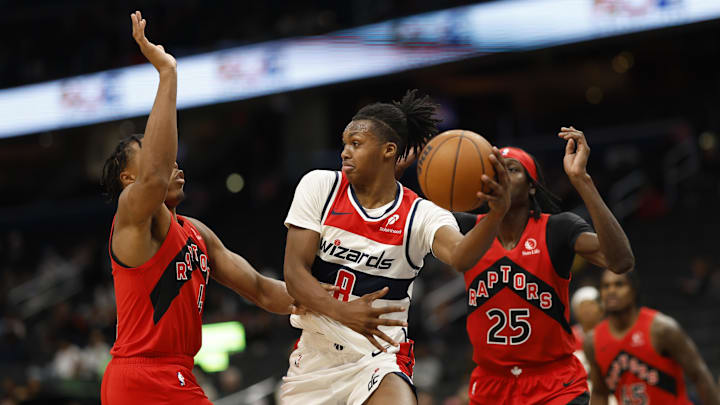 Oct 11, 2024; Washington, District of Columbia, USA; Washington Wizards guard Bub Carrington (8) leaps to pass the ball Toronto Raptors forward Scottie Barnes (4) defends in the second quarter at Capital One Arena. Mandatory Credit: Geoff Burke-Imagn Images