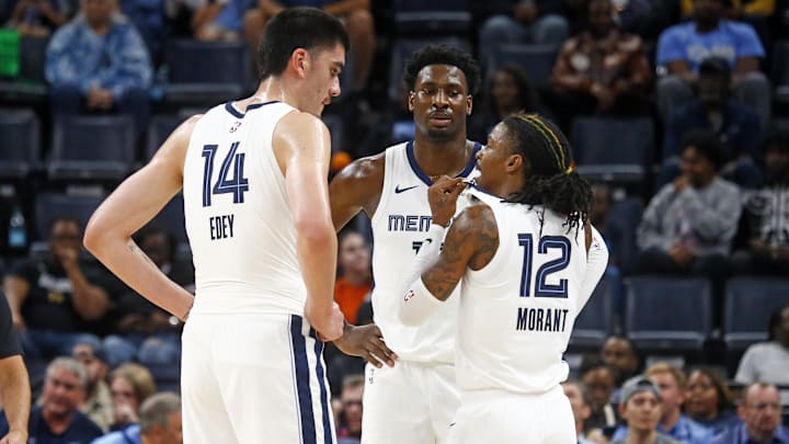 Oct 30, 2024; Memphis, Tennessee, USA; Memphis Grizzlies guard Ja Morant (12) talks with center Zach Edey (14) and forward Jaren Jackson Jr. (13) during the first half against the Brooklyn Nets at FedExForum. Mandatory Credit: Petre Thomas-Imagn Images