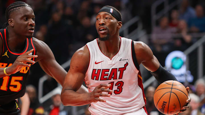 Apr 9, 2024; Atlanta, Georgia, USA; Miami Heat center Bam Adebayo (13) is defended by Atlanta Hawks center Clint Capela (15) in the first quarter at State Farm Arena. Mandatory Credit: Brett Davis-Imagn Images