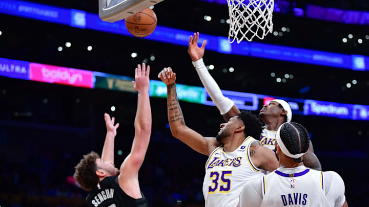 Dec 2, 2023; Los Angeles, California, USA; Los Angeles Lakers forward Christian Wood (35) and forward Jarred Vanderbilt (2) play for the rebound against Houston Rockets center Alperen Sengun (28) during the first half at Crypto.com Arena. Mandatory Credit: Gary A. Vasquez-Imagn Images