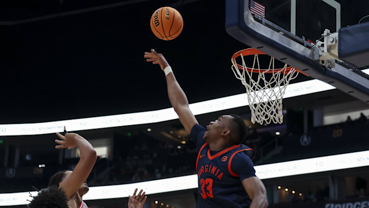 Feb 14, 2026; Nashville, Tennessee, USA; Virginia Cavaliers center Ugonna Onyenso (33) blocks the shot of Ohio State Buckeyes guard Bruce Thornton (2) during the first half at Bridgestone Arena. Mandatory Credit: Steve Roberts-Imagn Images Feb 14, 2026; Nashville, Tennessee, USA; Virginia Cavaliers center Ugonna Onyenso (33) blocks the shot of Ohio State Buckeyes guard Bruce Thornton (2) during the first half at Bridgestone Arena. Mandatory Credit: Steve Roberts-Imagn Images