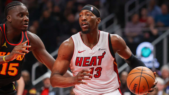 Apr 9, 2024; Atlanta, Georgia, USA; Miami Heat center Bam Adebayo (13) is defended by Atlanta Hawks center Clint Capela (15) in the first quarter at State Farm Arena. Mandatory Credit: Brett Davis-USA TODAY Sports