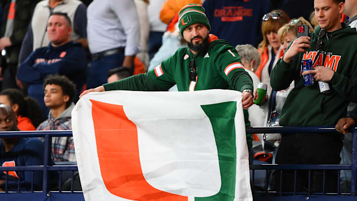Nov 30, 2024; Syracuse, New York, USA; A Miami Hurricanes fan holds a flag during the first half against the Syracuse Orange at the JMA Wireless Dome. Mandatory Credit: Rich Barnes-Imagn Images