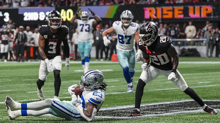 Nov 3, 2024; Atlanta, Georgia, USA; Dallas Cowboys running back Rico Dowdle (23) makes a juggling catch for a touchdown against Atlanta Falcons cornerback Dee Alford (20) during the first half at Mercedes-Benz Stadium. Mandatory Credit: Dale Zanine-Imagn Images