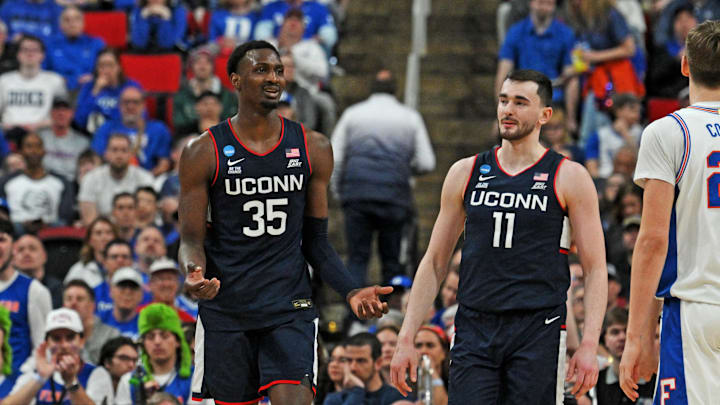 Mar 23, 2025; Raleigh, NC, USA; Connecticut Huskies center Samson Johnson (35) and Connecticut Huskies forward Alex Karaban (11) react after a play during the second half against the Florida Gators in the second round of the NCAA Tournament at Lenovo Center. Mandatory Credit: Zachary Taft-Imagn Images Mar 23, 2025; Raleigh, NC, USA; Connecticut Huskies center Samson Johnson (35) and Connecticut Huskies forward Alex Karaban (11) react after a play during the second half against the Florida Gators in the second round of the NCAA Tournament at Lenovo Center. Mandatory Credit: Zachary Taft-Imagn Images