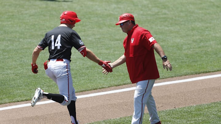 Jun 19, 2021; Omaha, Nebraska, USA; NC State Wolfpack left fielder Jonny Butler (14) is congratulated by head coach Elliott Avent after hitting a home run against the Stanford Cardinal at TD Ameritrade Park. Mandatory Credit: Bruce Thorson-Imagn Images Jun 19, 2021; Omaha, Nebraska, USA; NC State Wolfpack left fielder Jonny Butler (14) is congratulated by head coach Elliott Avent after hitting a home run against the Stanford Cardinal at TD Ameritrade Park. Mandatory Credit: Bruce Thorson-Imagn Images