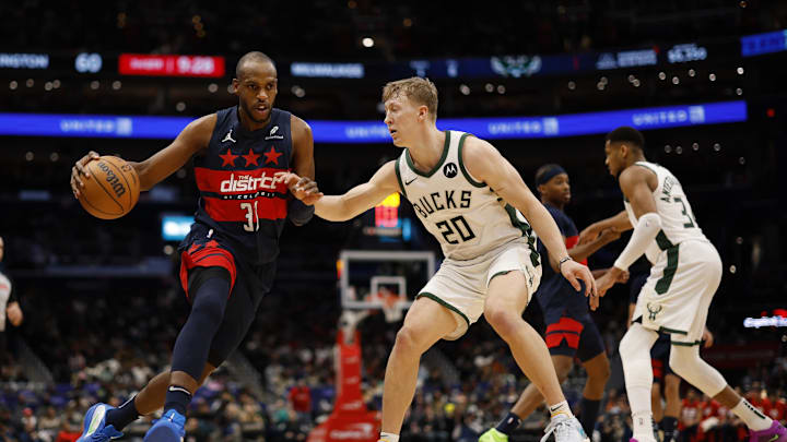 Feb 21, 2025; Washington, District of Columbia, USA; Washington Wizards forward Khris Middleton (32) drives to the basket as Milwaukee Bucks guard AJ Green (20) defends in the second half at Capital One Arena. Mandatory Credit: Geoff Burke-Imagn Images