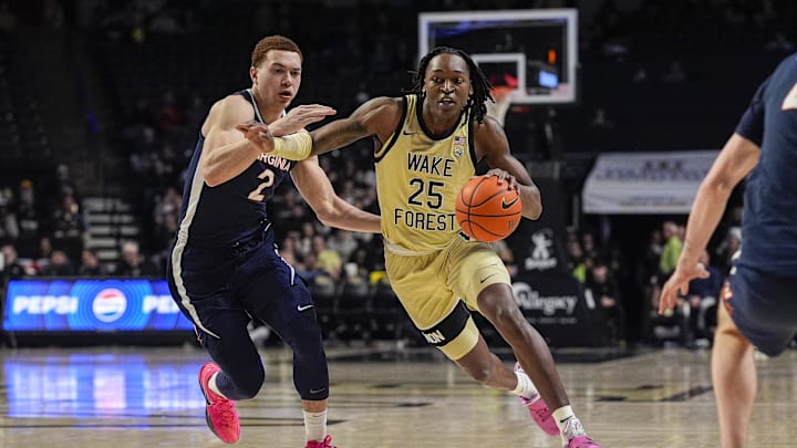 Feb 26, 2025; Winston-Salem, North Carolina, USA; Wake Forest Demon Deacons forward Tre'Von Spillers (25) handles the ball defended by Virginia Cavaliers forward Elijah Saunders (2) during the first half at Lawrence Joel Veterans Memorial Coliseum. Mandatory Credit: Jim Dedmon-Imagn Images Feb 26, 2025; Winston-Salem, North Carolina, USA; Wake Forest Demon Deacons forward Tre'Von Spillers (25) handles the ball defended by Virginia Cavaliers forward Elijah Saunders (2) during the first half at Lawrence Joel Veterans Memorial Coliseum. Mandatory Credit: Jim Dedmon-Imagn Images