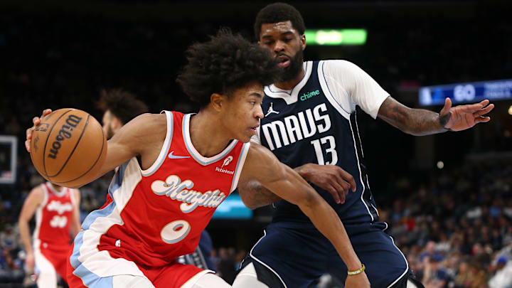 Jan 6, 2025; Memphis, Tennessee, USA; Memphis Grizzlies forward Jaylen Wells (0) drives to the basket as Dallas Mavericks forward Naji Marshall (13) defends during the third quarter at FedExForum. Mandatory Credit: Petre Thomas-Imagn Images