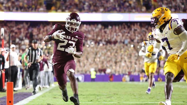 Texas A&M Aggies running back Jamarion Morrow (23) runs for a touchdown against Louisiana State Tigers linebacker Harold Perkins Jr. (7) during the second half at Tiger Stadium. 