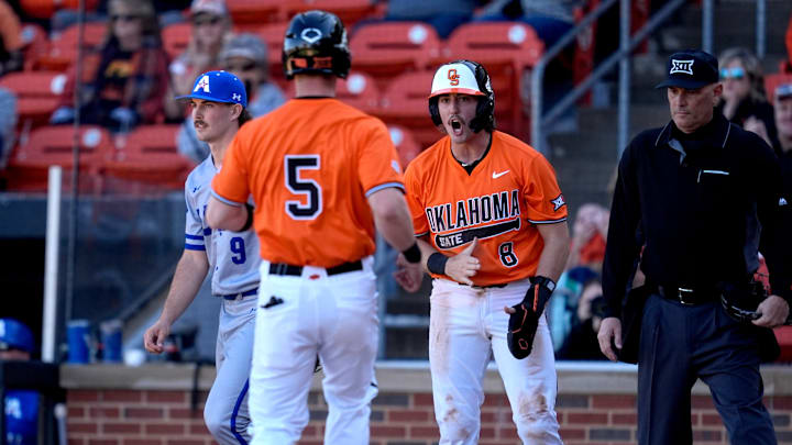 Oklahoma State's Ian Daugherty (8) celebrate a score with Garrett Shull (5) during the college baseball game between the Oklahoma State University Cowboys and the UT Arlington at O'Brate Stadium in Stillwater, Okla., Sunday, Feb., 23, 2025.