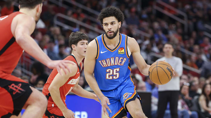 Dec 1, 2024; Houston, Texas, USA; Oklahoma City Thunder guard Ajay Mitchell (25) controls the ball during the game against the Houston Rockets at Toyota Center. Mandatory Credit: Troy Taormina-Imagn Images Dec 1, 2024; Houston, Texas, USA; Oklahoma City Thunder guard Ajay Mitchell (25) controls the ball during the game against the Houston Rockets at Toyota Center. Mandatory Credit: Troy Taormina-Imagn Images