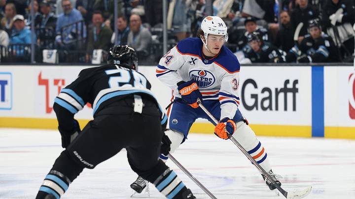 Apr 7, 2026; Salt Lake City, Utah, USA; Edmonton Oilers center Colton Dach (34) skates with the puck against Utah Mammoth defenseman Ian Cole (28) during the second period at Delta Center. Mandatory Credit: Rob Gray-Imagn Images