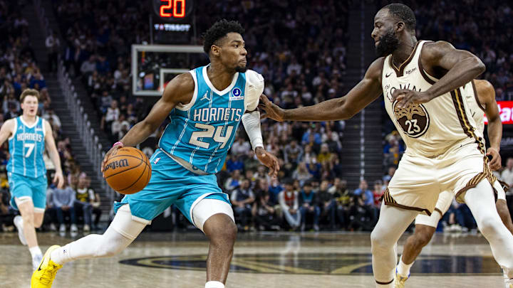 Charlotte Hornets forward Brandon Miller (24) drives to the basket as Golden State Warriors forward Draymond Green (23) defends