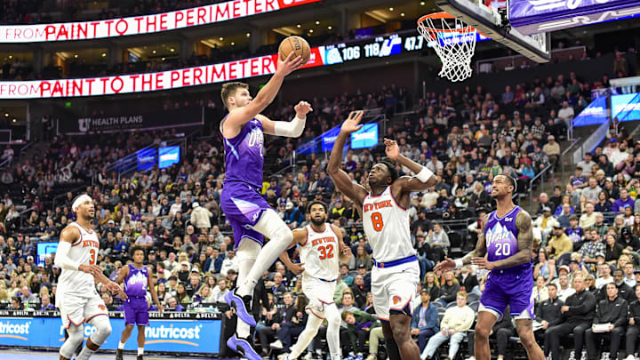 Nov 23, 2024; Salt Lake City, Utah, USA; Utah Jazz center Walker Kessler (24) takes a layup over New York Knicks forward/guard OG Anunoby (8) during the second half at the Delta Center. Mandatory Credit: Christopher Creveling-Imagn Images