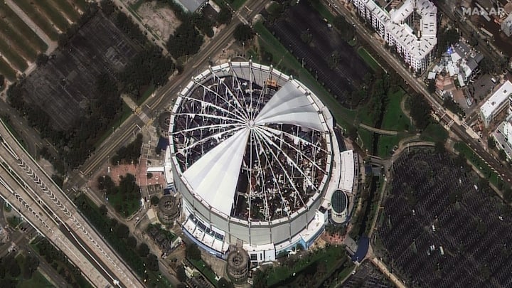 The roof of Tropicana Field, home of the Tampa Bay Rays MLB team, was torn off by Hurricane Milton's powerful winds. Satellite imagery from Maxar shows the destruction on Oct. 10, 2024. The roof of Tropicana Field, home of the Tampa Bay Rays MLB team, was torn off by Hurricane Milton's powerful winds. Satellite imagery from Maxar shows the destruction on Oct. 10, 2024.