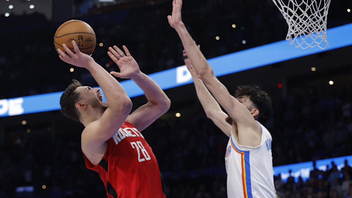Feb 7, 2026; Oklahoma City, Oklahoma, USA; Houston Rockets center Alperen Sengun (28) shoots as Oklahoma City Thunder center/forward Chet Holmgren (7) defends during the second half at Paycom Center. Mandatory Credit: Alonzo Adams-Imagn Images