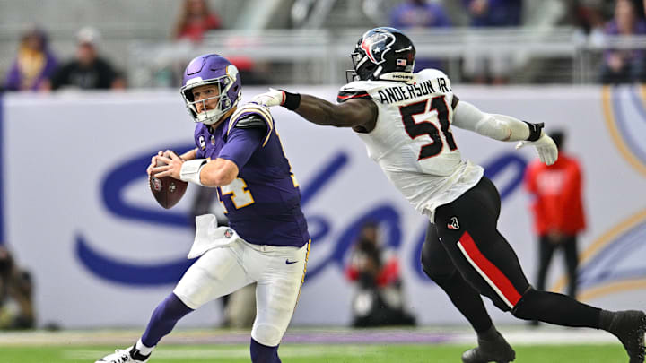 Sep 22, 2024; Minneapolis, Minnesota, USA; Minnesota Vikings quarterback Sam Darnold (14) and Houston Texans defensive end Will Anderson Jr. (51) in action during the game at U.S. Bank Stadium. Mandatory Credit: Jeffrey Becker-Imagn Images
